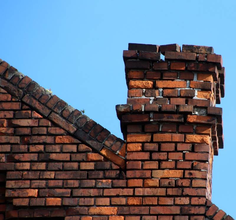 Damaged chimney on an Frederick home showing cracks and missing mortar